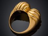a close up of a gold ring on a black surface