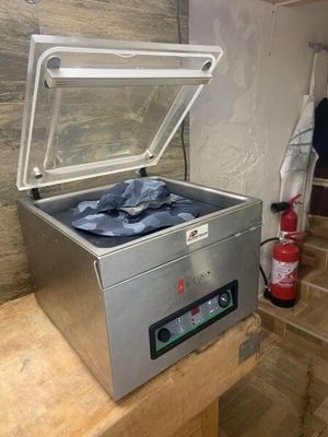 an image of a stainless steel chest freezer on a wooden table