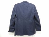 the back of a blue jacket hanging on a white wall