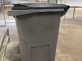 a trash can that is sitting in the middle of the floor