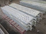 several pieces of metal are stacked on top of pallets in a warehouse