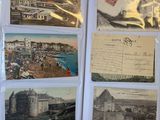 some old postcards are sitting on top of a table