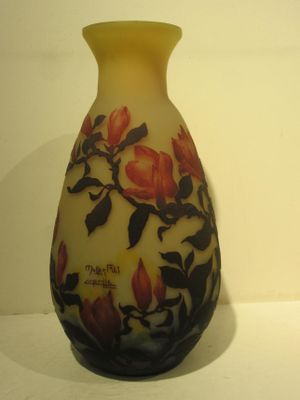 a vase with a floral design on it sitting on a table