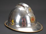 a silver helmet with a gold band around the brim