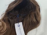 a label on the back of a hair piece