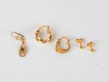 three pairs of gold hoop earrings and a pair of earrings
