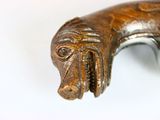a close up of a metal object with a dog head on it