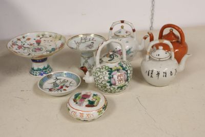 many different types of teapots and bowls on the table