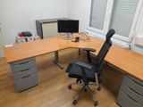 a desk with a chair and a computer on it