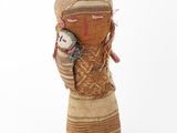 a small doll that is next to a pair of shoes
