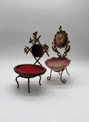 pair of antique brass and glass jewelry stands on a white background
