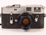 a black and silver camera with a strap on it