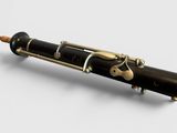 a close up of a black and gold pen sitting on top of a white surface