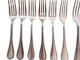 a lot of forks and spoons that are on a table