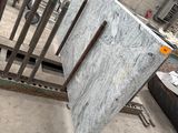 a pile of marble on the ground in a warehouse
