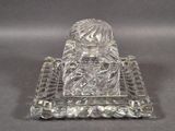 a glass figurine on a glass tray on a table