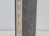 the book is sitting on a wooden table with a white background
