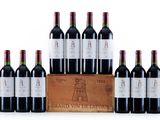 a group of bottles of red wine in a wooden crate