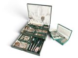 a green case with silverware in it on a white surface
