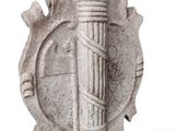 a stone sculpture of a man holding a wooden pole