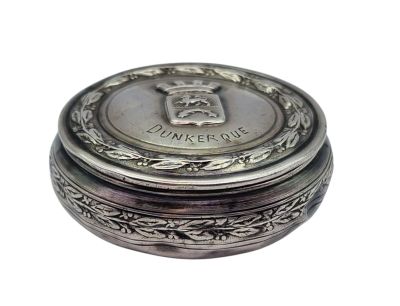 a small silver box with a crown on top of it