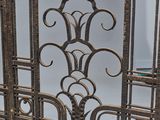 an image of a metal gate with a decorative design on it