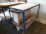 two tables that are sitting on a cart in the room