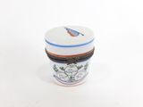 a small container with a bird on it on a white surface
