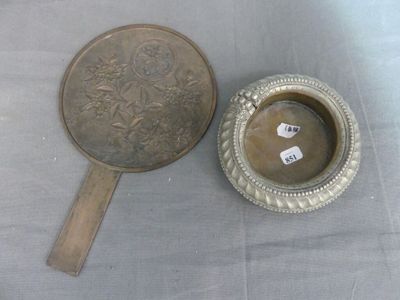 a silver plate with a mirror on it next to a mirror