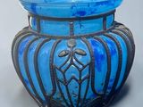un vase en verre bleu orné d'un motif décoratif