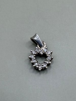 an image of a small diamond pendant on a table