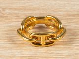an image of a gold ring on a wooden surface
