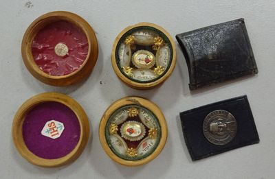four small wooden boxes that have various items in them