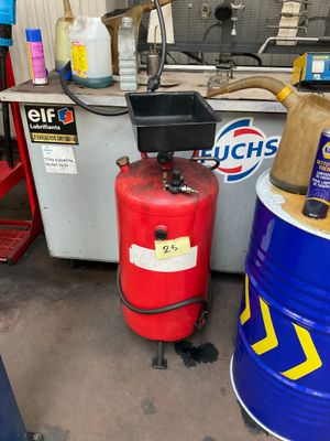 two red barrels sitting next to each other in a garage