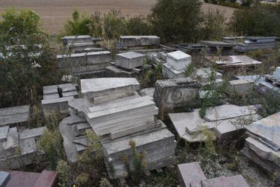 a lot of old tombstones in a field
