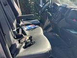 the interior of a vehicle with a seat and steering controls