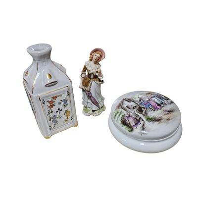 a small vase and a small vase with a figurine on it