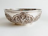 an image of a silver bowl on a white surface