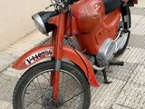 a red motorcycle that is parked on the side of the street