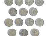 several coins are arranged in a circle on a white surface