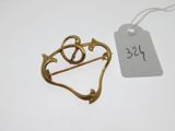 a gold plated brooch with a heart and arrow on it