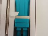 a blue watch in a box with a pen in it