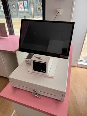 a pink desk with a computer on top of it