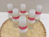 bottles of lotion sitting on top of a bamboo tray on a table