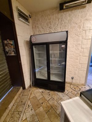 a refrigerator that is sitting in the corner of a room