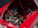 a red car with an engine in the trunk