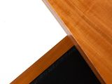 a wooden desk with a white paper on top of it
