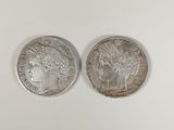 two silver coins, one of which has a head of a woman and one of which is a head of
