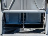 a silver truck with two seats in the back of it