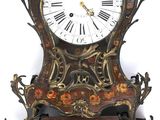 a clock that is hanging on the wall next to a wall clock